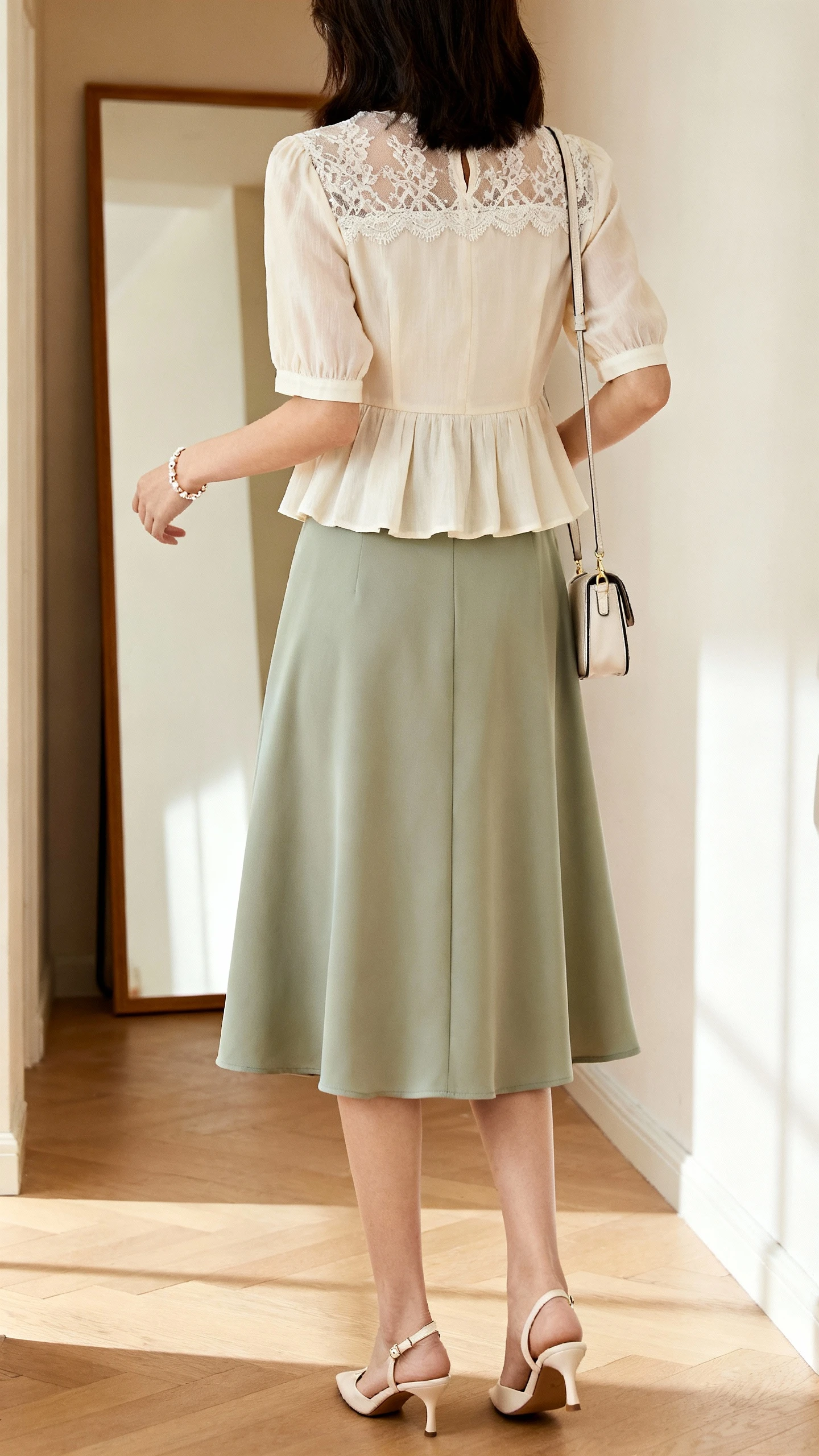 iPhone back view of a woman wearing a lace-trim peplum blouse paired with a graceful midi skirt, dainty bracelet, kitten heels, small crossbody bag, face not visible, hallway full-length mirror, soft morning light, iPhone photo quality.